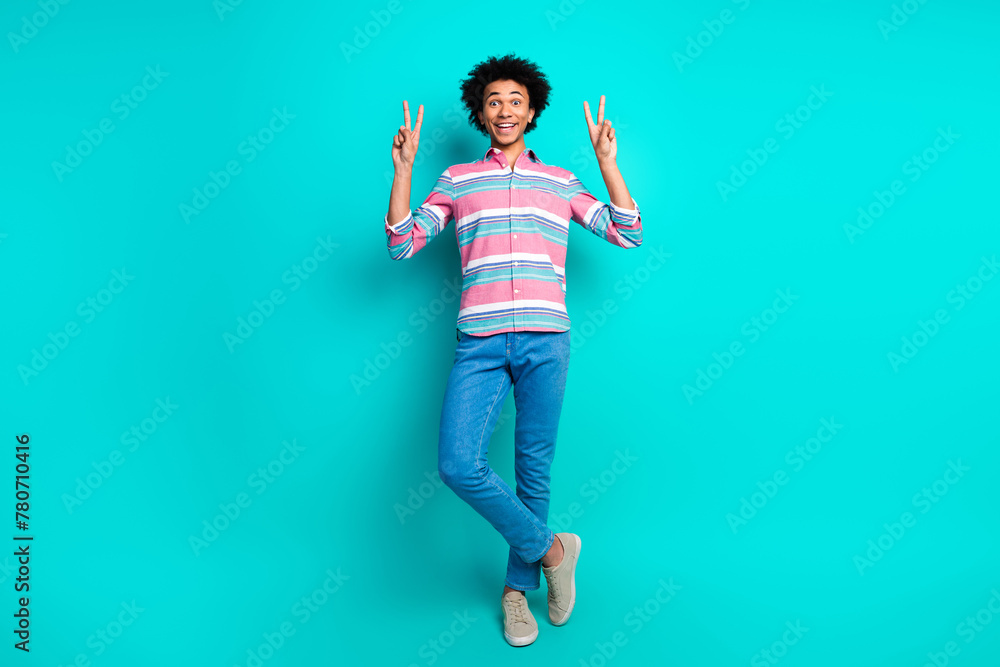 Photo of cheerful young man dressed stylish striped clothes v-sign isolated on cyan color background - obrazy, fototapety, plakaty 