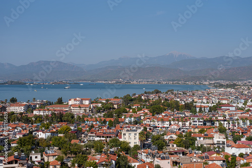 View of the city near the sea, a bay with yachts. From a bird's-eye view. Orange roofs. The Turkish city of Fethiye.