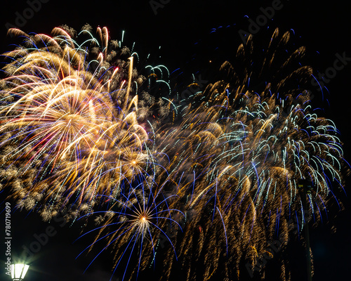Fireworks in the night sky aftr a baseball game.