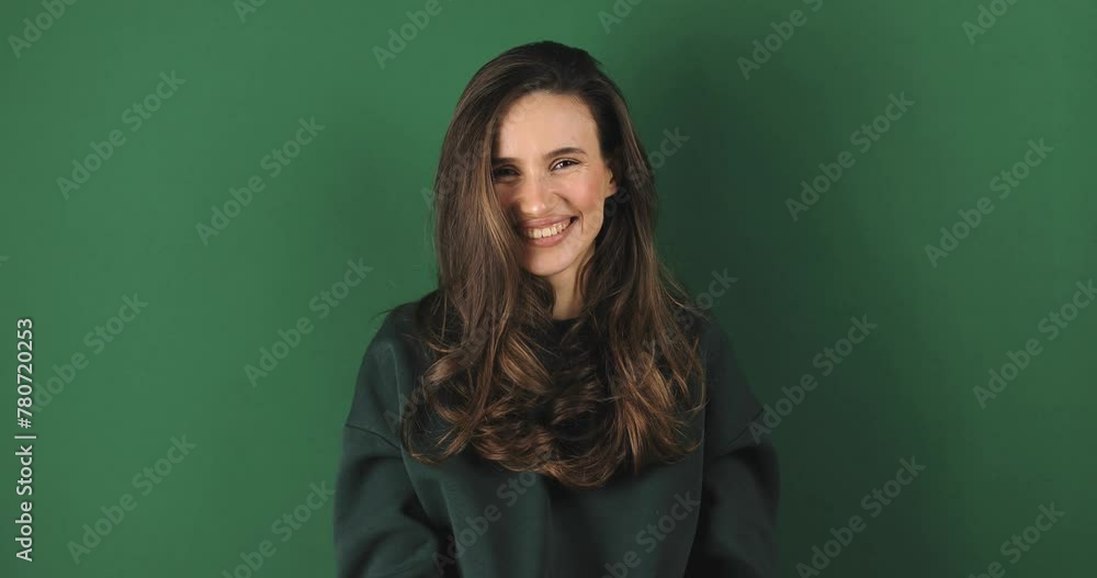 Happy woman wear green sweatshirt send air kiss on green studio. Attractive girl send blowing kiss. Female freedom lifestyle. Glamour chic sending kiss to camera. Female love story emotion Happy woman wear green sweatshirt send air kiss on green studio. Attractive girl send blowing kiss. Female freedom lifestyle. Glamour chic sending kiss to camera. Female love story emotion