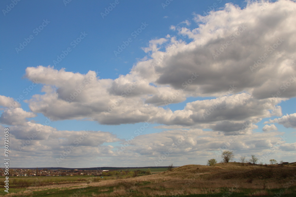 A field with a blue sky and clouds A field with a blue sky and clouds