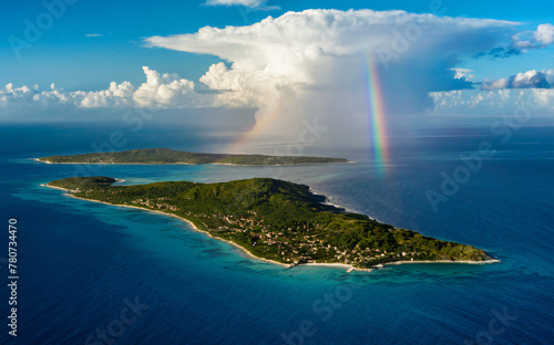 Aerial view of a tropical island after storm rainbow