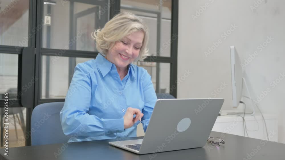 Senior Old Woman Pointing at Camera while Working on Laptop Senior Old Woman Pointing at Camera while Working on Laptop