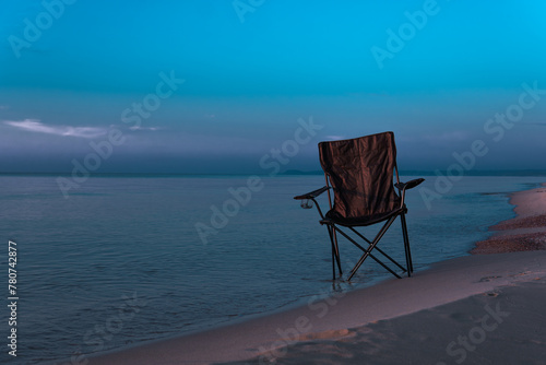 lonely chair in the middle of the sea and a beautiful sunrise