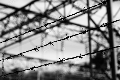 Barbed wire of a refugee camp with impossible escape in dramatic effect