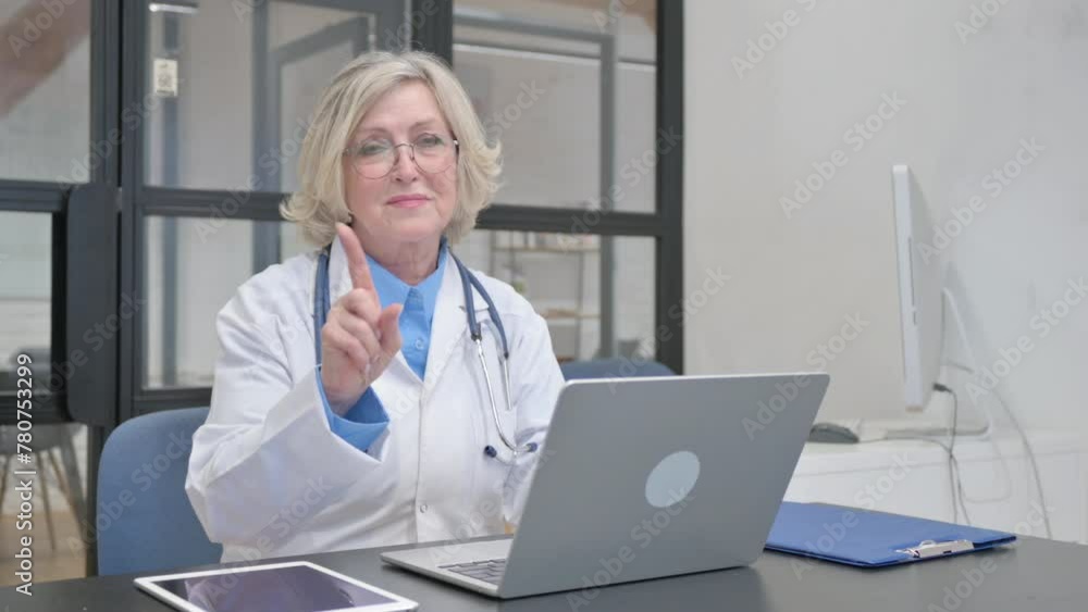 Restricting Senior Female Doctor in Denial Looking at Camera Restricting Senior Female Doctor in Denial Looking at Camera