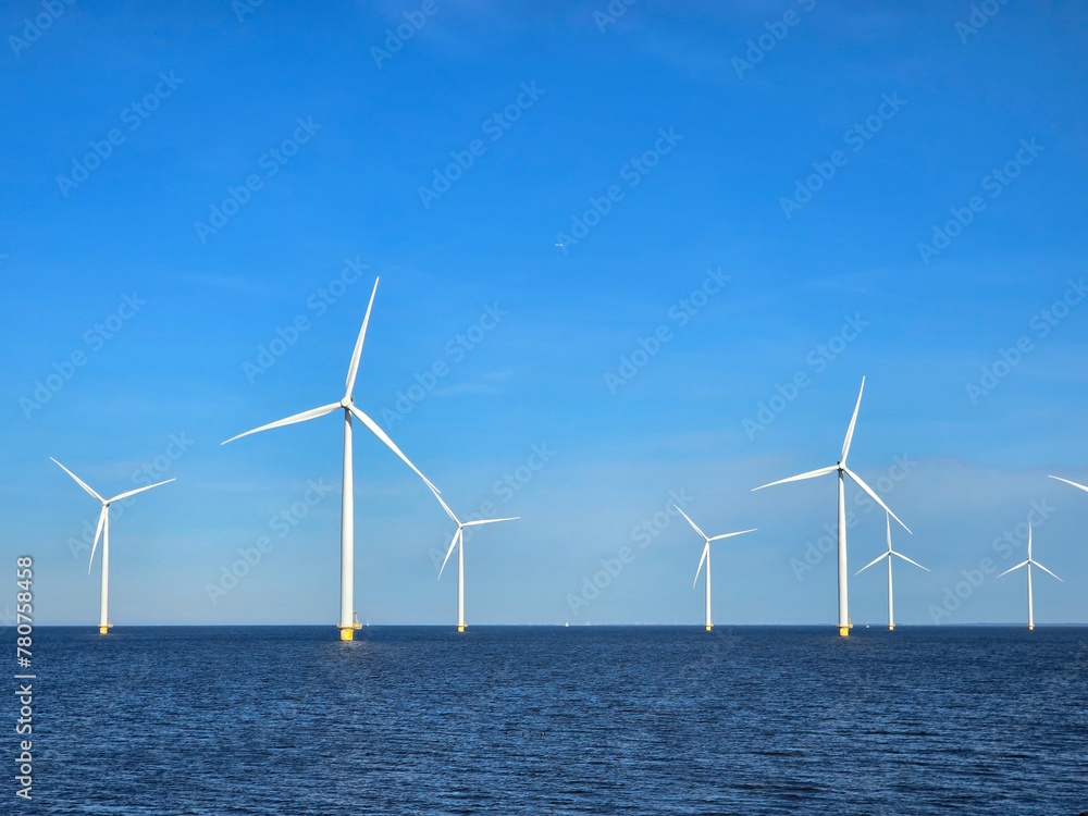 Windmill park in the ocean, drone aerial view of windmill turbines at sea in the Netherlands