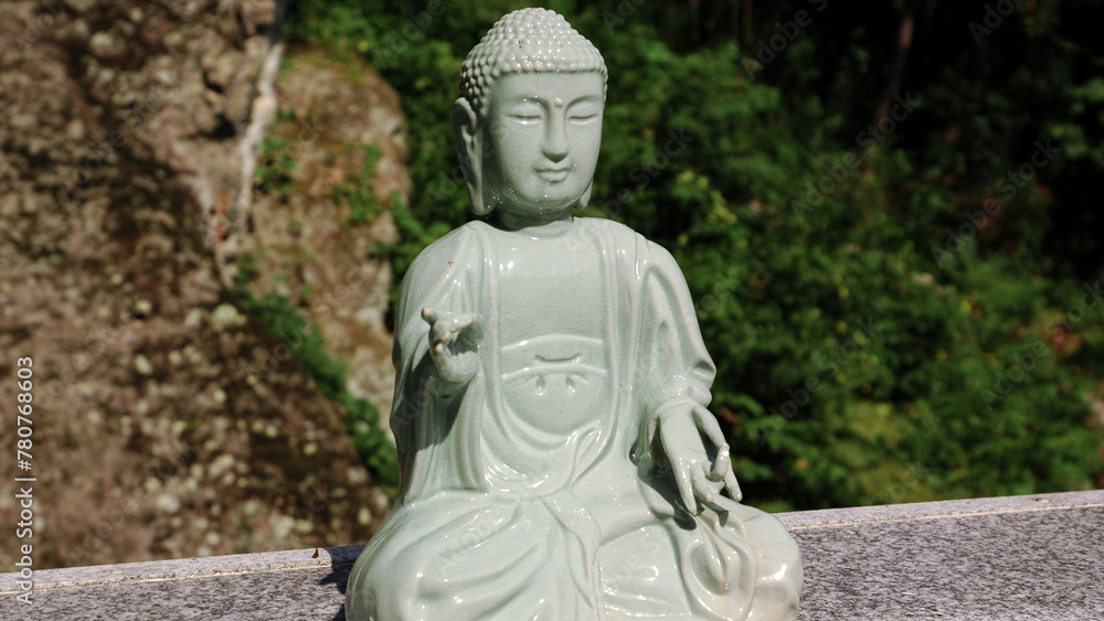 A large stone statue of a seated Buddha. Garden Sculptures. South Korea A large stone statue of a seated Buddha. Garden Sculptures. South Korea