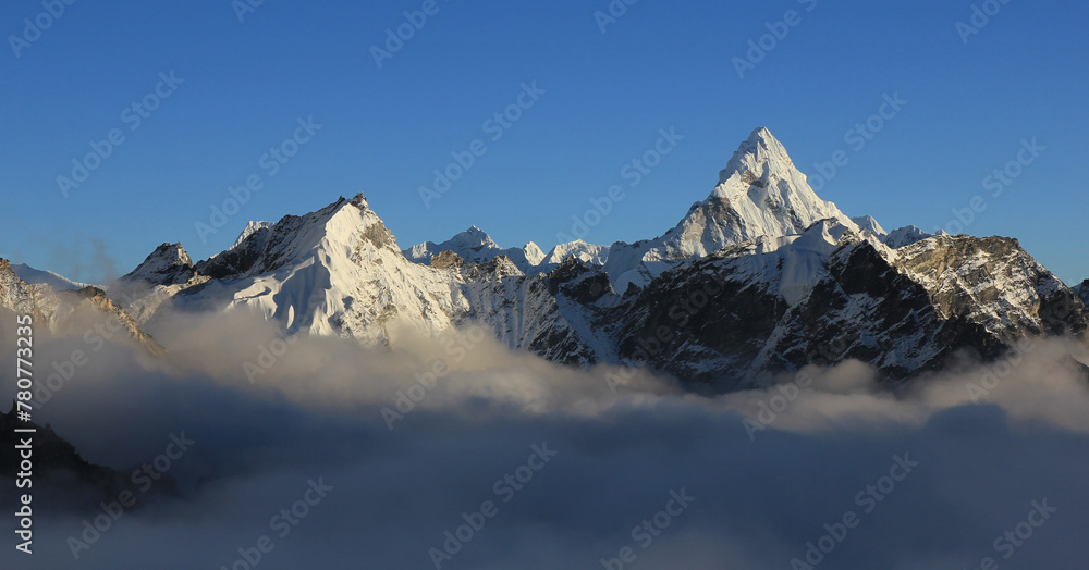 Mount Ama Dablam and other mountains reaching out of a sea of fog, Nepal. Mount Ama Dablam and other mountains reaching out of a sea of fog, Nepal.