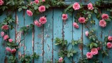   A wooden fence is adorned with a collection of pink roses, their green leaves and stems accompanying them on the fence's side