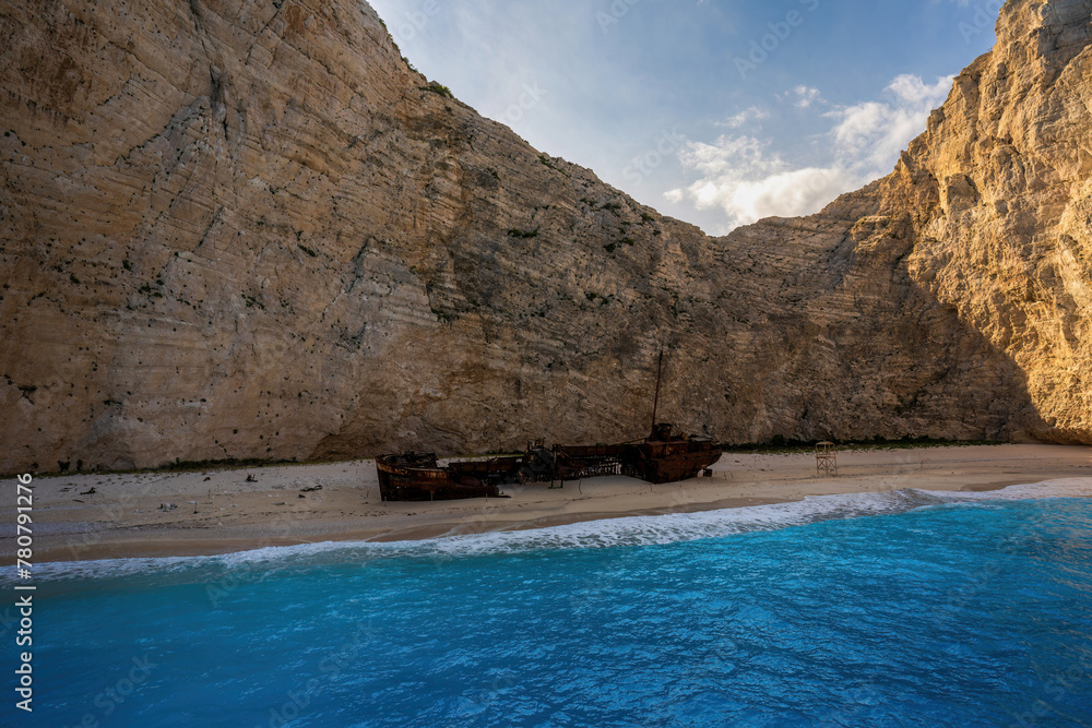 Panoramic view of the famous Navagio shipwreck beach on Zakynthos island, Greece, with people enjoying the light blue colored sea