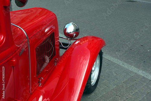 Side view to fragment of retro hot rod car color red closeup