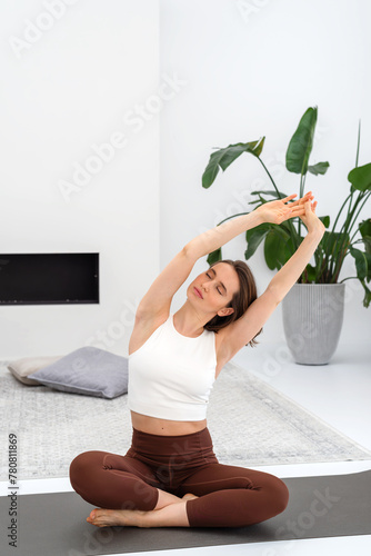Young woman doing exercise on a mat during yoga practice.