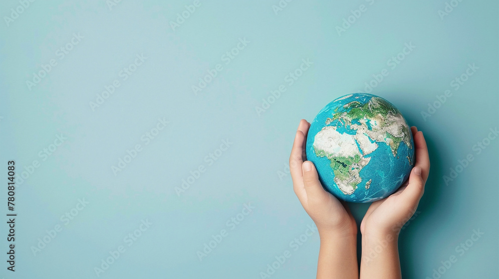 Earth globe planet in kid's tender hands against blue background with copy space. World environment day. Earth world protection concept. Earth globe planet in kid's tender hands against blue background with copy space. World environment day. Earth world protection concept.