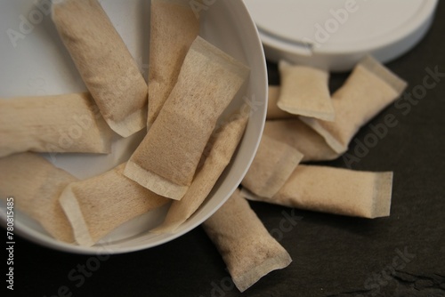 Light brown nicotine pads, spilled by the package. High quality photo