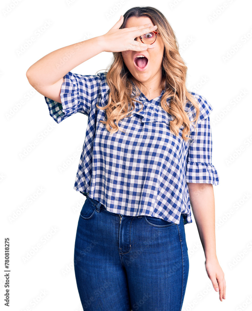 Young caucasian woman wearing casual clothes peeking in shock covering face and eyes with hand, looking through fingers with embarrassed expression. Young caucasian woman wearing casual clothes peeking in shock covering face and eyes with hand, looking through fingers with embarrassed expression.