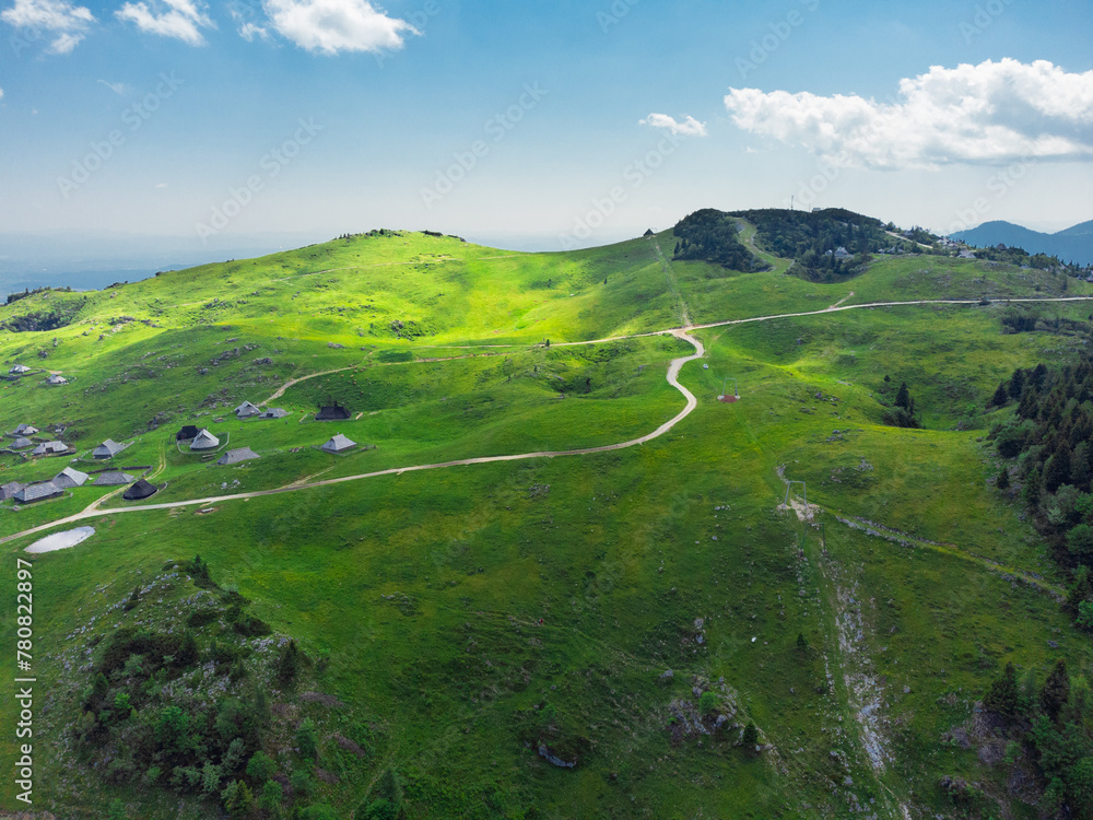 Aerial View of Mountain Cottages on Green Hill of Velika Planina Big Pasture Plateau, Alpine Meadow Landscape, Slovenia