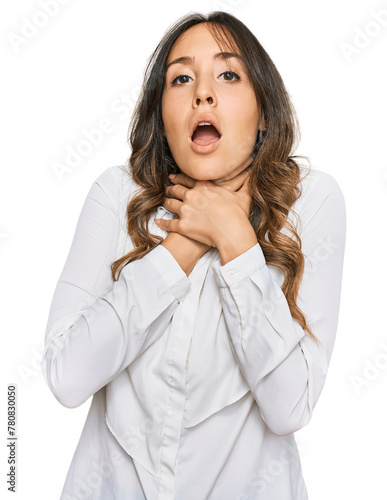 Young brunette woman wearing casual clothes shouting and suffocate because painful strangle. health problem. asphyxiate and suicide concept.