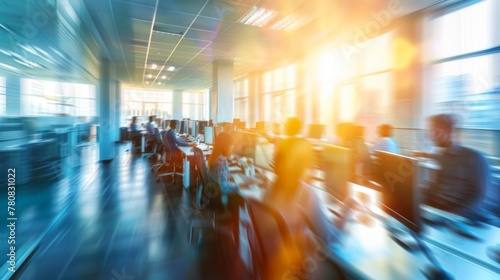 Blurred background of a modern open space office with business people working on computers in blurred motion 