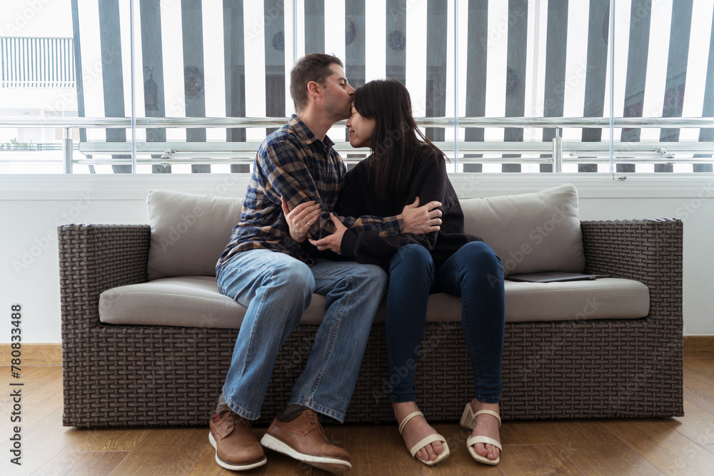 Intimate moment between diverse couples on a sofa Intimate moment between diverse couples on a sofa