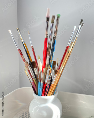 Paint brushes, spatula, pencil and artist material in a studio. Art supplies. Creative tools.