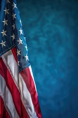 Close-up of an American flag against a blue background. Suitable for patriotic themes
