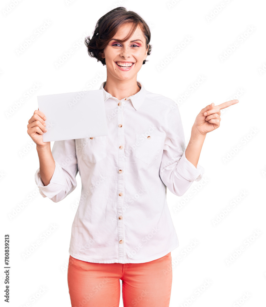 Beautiful young woman with short hair holding blank empty banner smiling happy pointing with hand and finger to the side Beautiful young woman with short hair holding blank empty banner smiling happy pointing with hand and finger to the side