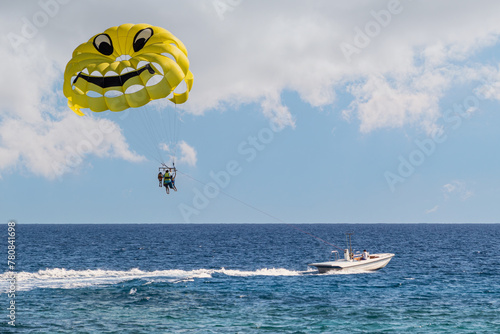 Parasailing in the sea. A popular tourist pastime with a parasailing parachute attached to a motorboat photo