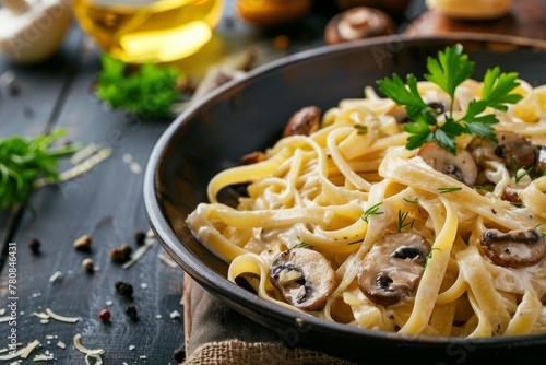 Traditional Italian homemade fettuccine pasta with mushrooms and cream sauce Fettuccine al Funghi Porcini served on a dark table with rustic wooden