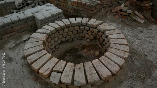 Partially built circular pit made of bricks in an under-construction setting Mohenjo Daro