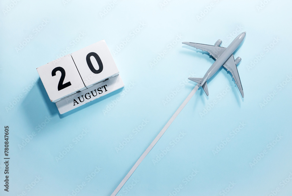 August calendar with number 20. Top view of a calendar with a flying passenger plane. Scheduler. Travel concept. Copy space. August calendar with number 20. Top view of a calendar with a flying passenger plane. Scheduler. Travel concept. Copy space.
