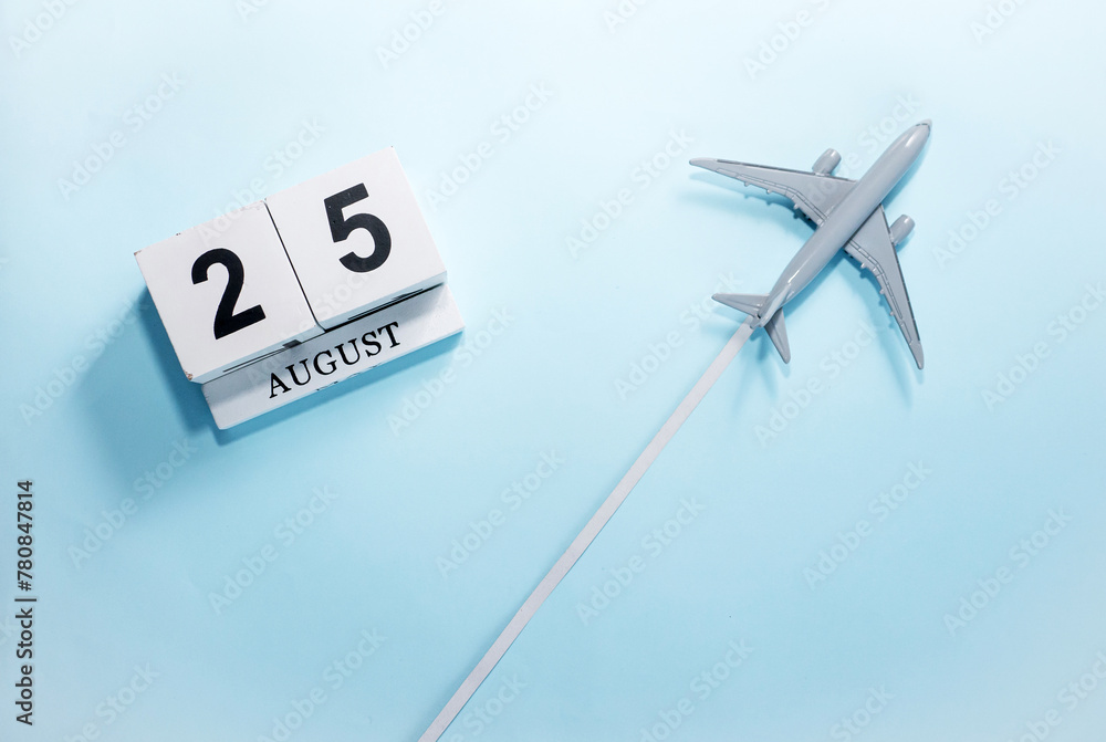 August calendar with number 25. Top view of a calendar with a flying passenger plane. Scheduler. Travel concept. Copy space. August calendar with number 25. Top view of a calendar with a flying passenger plane. Scheduler. Travel concept. Copy space.