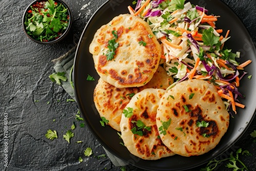 Vegetarian fried Pupusas with coleslaw on plate top view photo