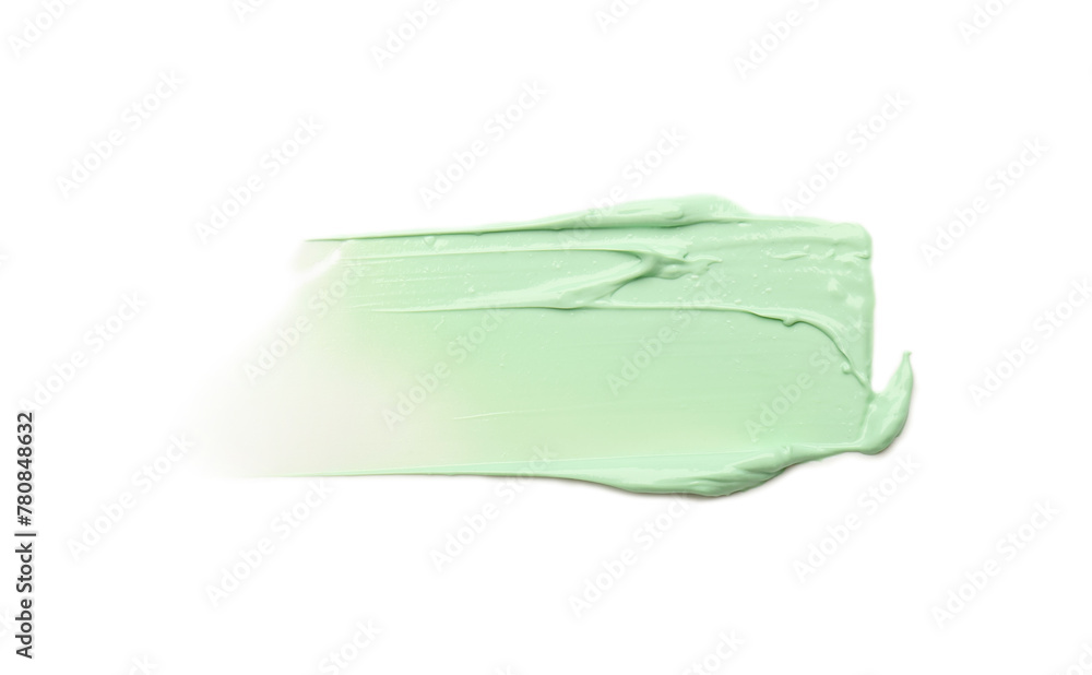 Strokes of green color correcting concealer isolated on white, top view