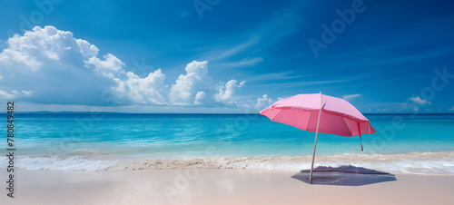Serene Beach Day with Vibrant Orange and Red Parasol under Sunny Blue Skies