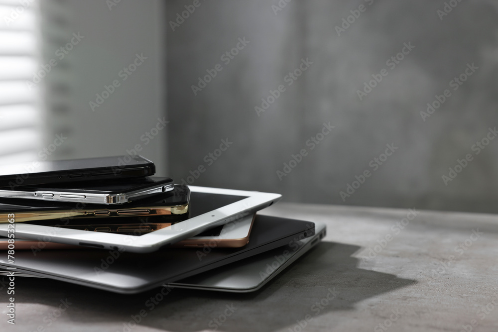 Many different modern gadgets on grey table indoors. Space for text - obrazy, fototapety, plakaty 