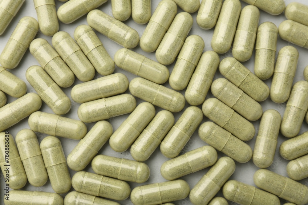Vitamin capsules on light grey background, top view. Health supplement Vitamin capsules on light grey background, top view. Health supplement