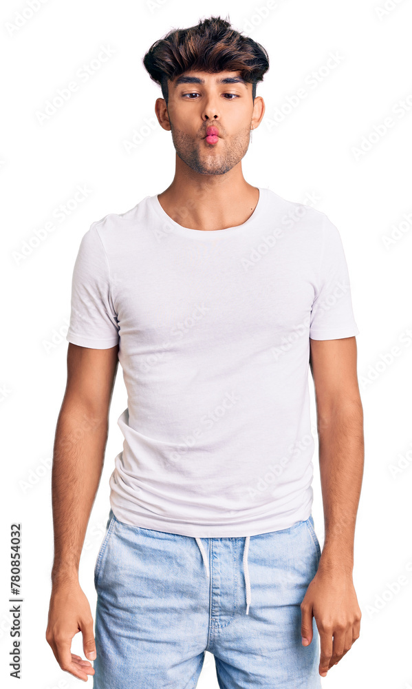Obraz premium Young hispanic man wearing casual clothes making fish face with lips, crazy and comical gesture. funny expression.