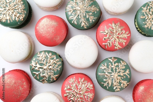 Beautifully decorated Christmas macarons on white background, top view photo