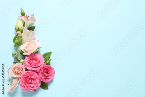 Happy Mother's Day. Beautiful flowers on light blue background, flat lay. Space for text