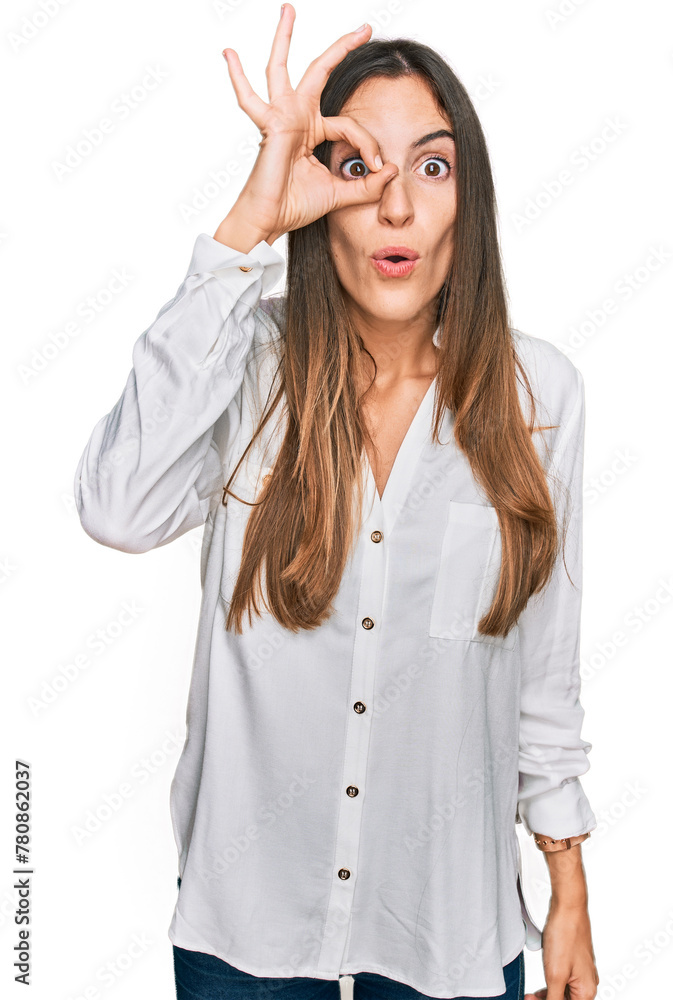 Young beautiful woman wearing casual clothes doing ok gesture shocked with surprised face, eye looking through fingers. unbelieving expression. Young beautiful woman wearing casual clothes doing ok gesture shocked with surprised face, eye looking through fingers. unbelieving expression.