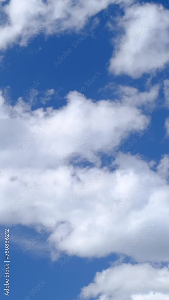 Cumulus clouds move across the blue sky. Vertical video. Cumulus clouds move across the blue sky. Vertical video.
