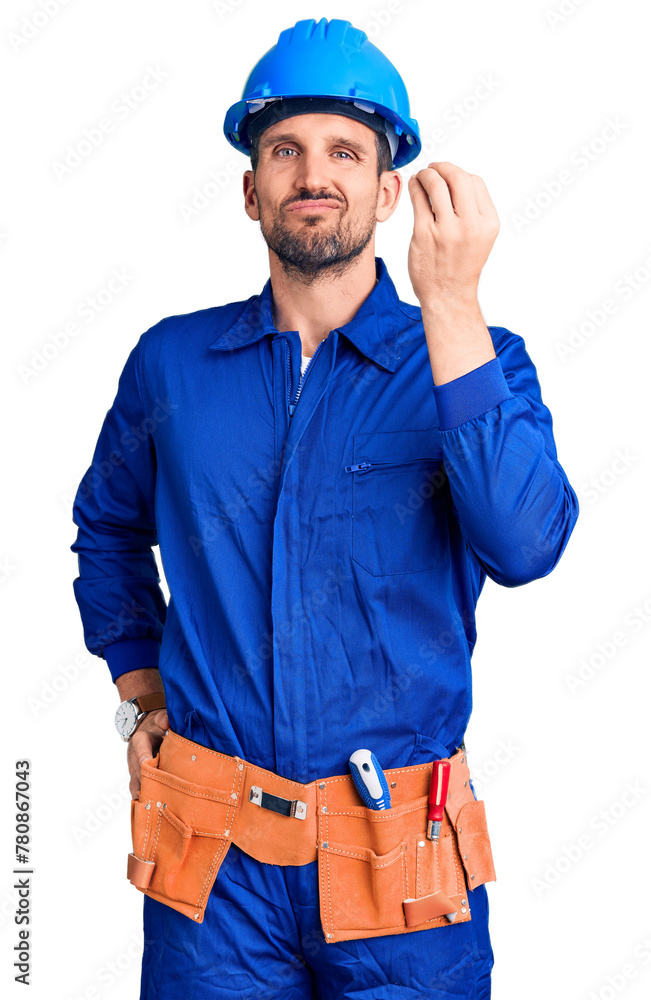Young handsome man wearing worker uniform and hardhat confused and annoyed with open palm showing copy space and pointing finger to forehead. think about it. Young handsome man wearing worker uniform and hardhat confused and annoyed with open palm showing copy space and pointing finger to forehead. think about it.