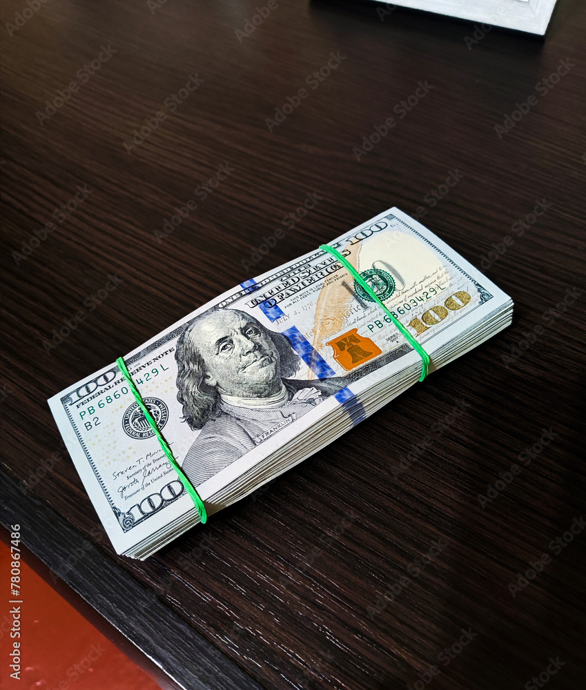 Hundred dollar bills on the table. Stack of money in dollars. Cash check in foreign currency. Hundred dollar bills on the table. Stack of money in dollars. Cash check in foreign currency.