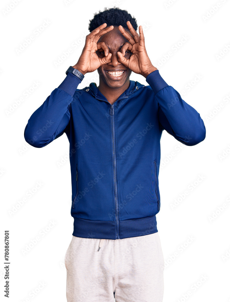 Young african american man wearing sportswear doing ok gesture like binoculars sticking tongue out, eyes looking through fingers. crazy expression. Young african american man wearing sportswear doing ok gesture like binoculars sticking tongue out, eyes looking through fingers. crazy expression.