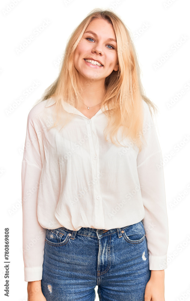 Young beautiful blonde woman wearing casual shirt looking positive and happy standing and smiling with a confident smile showing teeth Young beautiful blonde woman wearing casual shirt looking positive and happy standing and smiling with a confident smile showing teeth