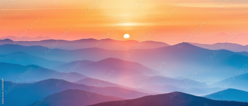 Panoramic view of layered mountains under a soft pink sunset sky.
