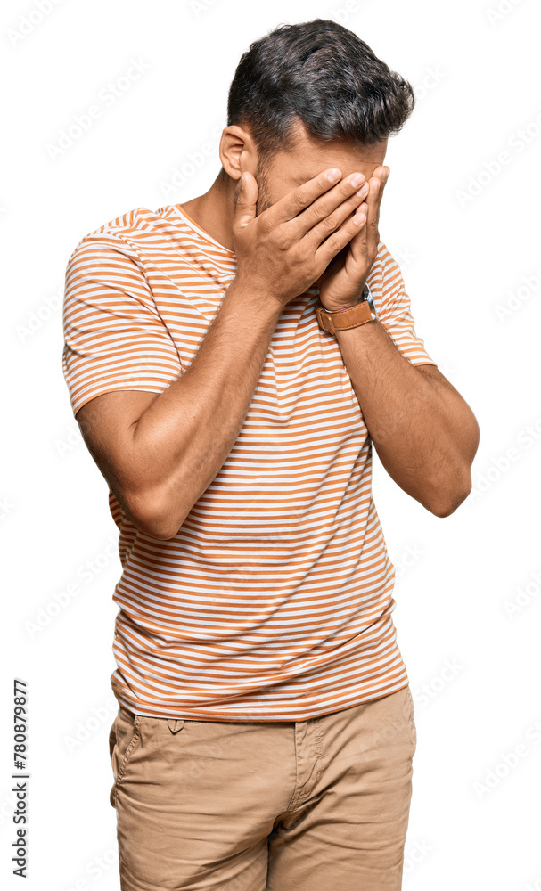 Handsome hispanic man wearing casual clothes with sad expression covering face with hands while crying. depression concept. Handsome hispanic man wearing casual clothes with sad expression covering face with hands while crying. depression concept.