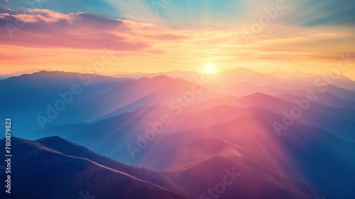 Sunrise over mountains with rays piercing through mist and trees. Warm, tranquil landscape.