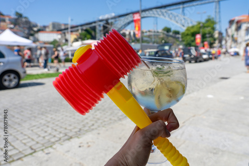 colorful plastic hammer with a porto tonic cocktail in Porto Portugal at sao joao festival saint john's day © Bernadett